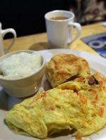 Alligator omelet, grits, and biscuit at Daisy Dukes